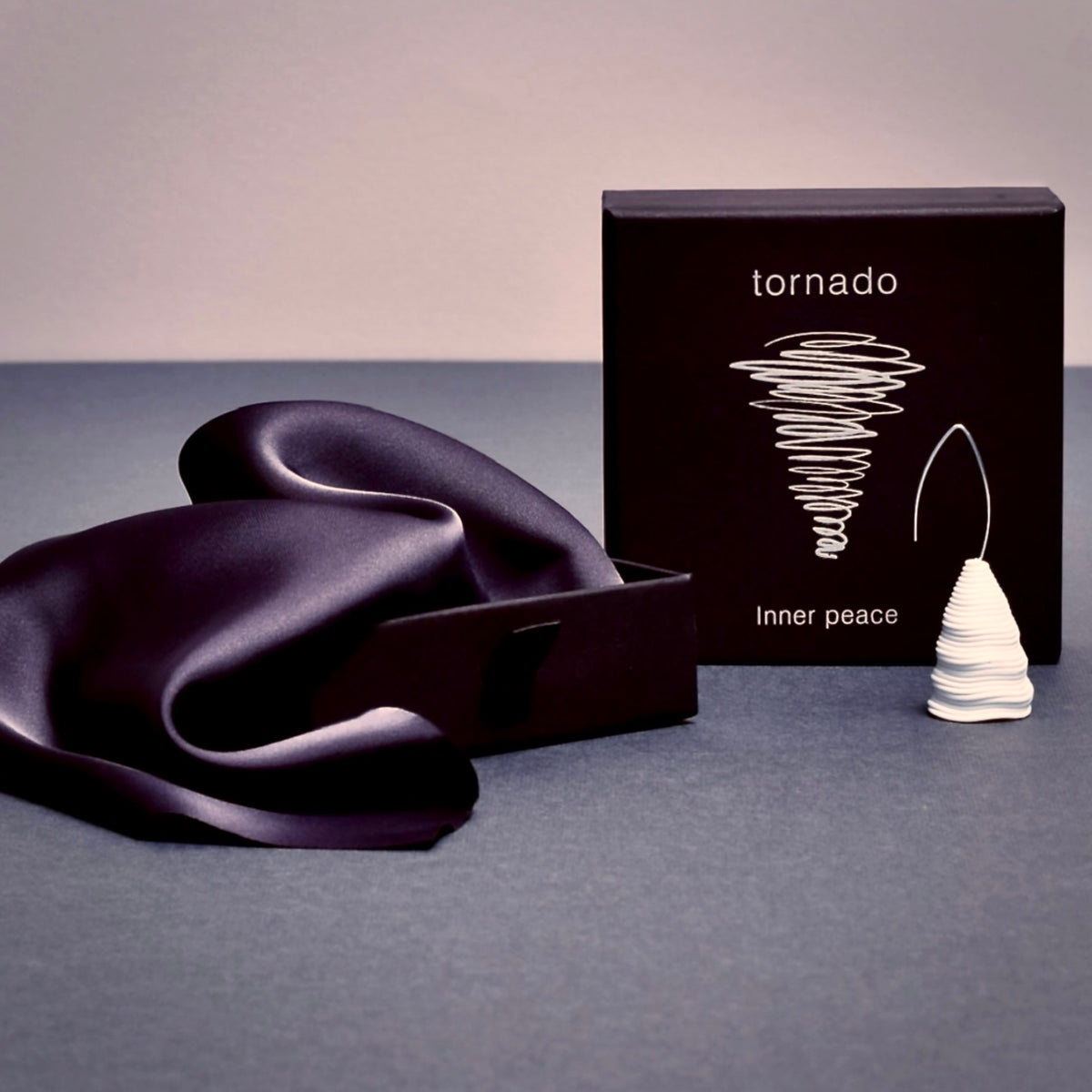 Elegant black packaging for the ‘Tornado’ porcelain earring by Serhiy Verbicki, featuring a minimalist design and a symbolic tornado illustration.
